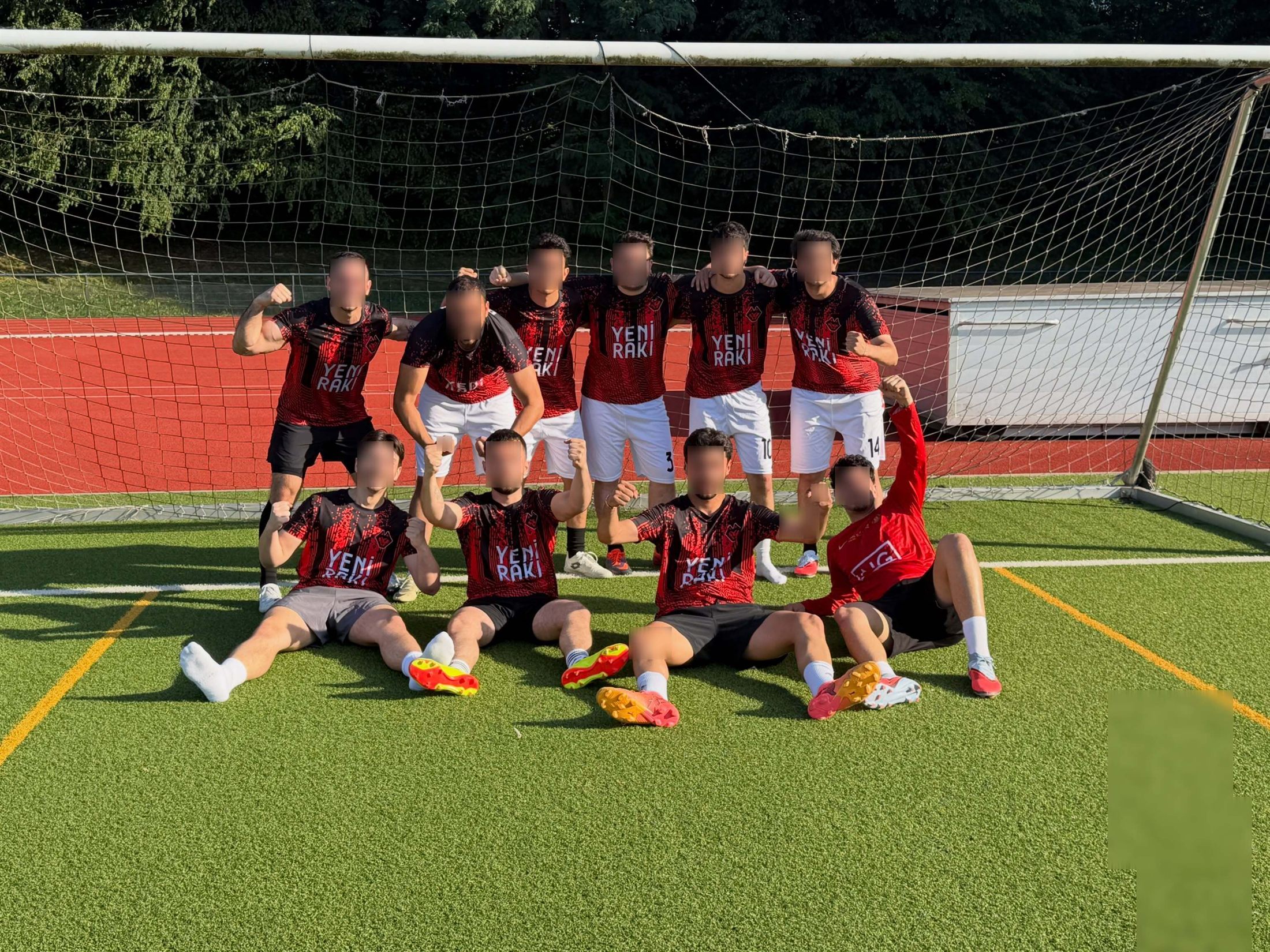 The squad posing in front of the goal in last season's red and black kit